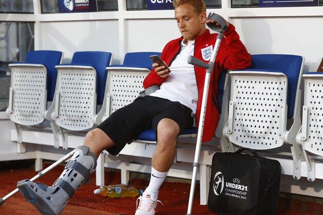 England's injured Alex Pritchard sits on the bench prior to the Euro U21 soccer championship group B match between England and Italy, at the Ander stadium in Olomouc, Czech Republic, Wednesday, June 24, 2015. (AP Photo/Matthias Schrader)