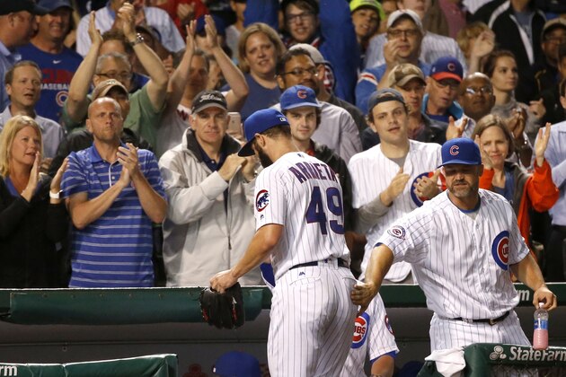 Chicago Cubs starting pitcher Jake Arrieta receives a standing ovation after pitching out of a bases-loaded jam with a strikeout of Los Angeles Dodgers pinch-hitter Justin Turner during the seventh inning of a baseball game Tuesday, May 31, 2016, in Chicago. (AP Photo/Charles Rex Arbogast)