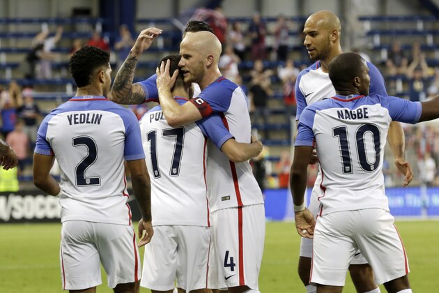 U.S. forward Christian Pulisic (17) is congratulated by his teammates after scoring against Bolivia in the second half of an international friendly soccer match, Saturday, May. 28, 2016, in Kansas City, Kan. (AP Photo/Colin E. Braley)