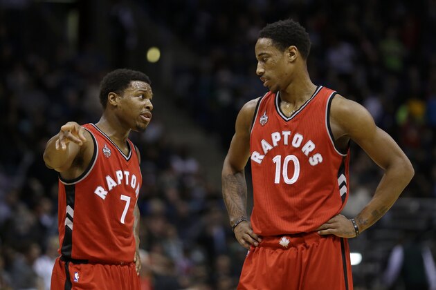 Toronto Raptors' Kyle Lowry (7) talks with DeMar DeRozan (10) during an NBA basketball game against the Milwaukee Bucks Saturday, Dec. 26, 2015, in Milwaukee. (AP Photo/Aaron Gash)