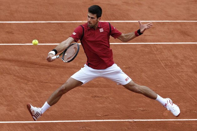 Serbia's Novak Djokovic returns the ball to Spain's Roberto Bautista Agut during their fourth round match of the French Open tennis tournament at the Roland Garros stadium, Wednesday, June 1, 2016 in Paris.  (AP Photo/Christophe Ena)