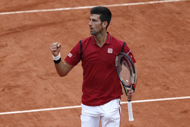 Serbia's Novak Djokovic clenches his fist as he defeats Spain's Roberto Bautista Agut after their fourth round match of the French Open tennis tournament at the Roland Garros stadium, Wednesday, June 1, 2016 in Paris.  (AP Photo/Christophe Ena)