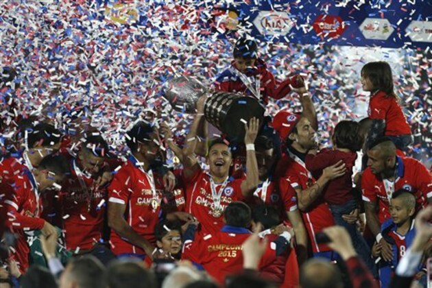 Chile's players hold up the trophy after the Copa America final soccer match against Argentina at the National Stadium in Santiago, Chile, Saturday, July 4, 2015. Chile's Bravo made a save and striker Alexis Sanchez converted the winning penalty as host Chile defeated Argentina 4-1 in a shootout after a 0-0 draw in the Copa America final on Saturday, finally winning its first major title. (AP Photo/Luis Hidalgo)