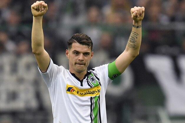 FILE - In this Sunday, April 3, 2016 file photo, Moenchengladbach's Granit Xhaka celebrates after the German Bundesliga soccer match between Borussia Moenchengladbach and Hertha BSC Berlin in Moenchengladbach, Germany. Arsenal has signed 23-year-old midfielder Granit Xhaka, Wednesday May 25, 2016, the team's first addition to the squad in the transfer window, after captaining the German team to fourth place in the Bundesliga. (AP Photo/Martin Meissner, File)