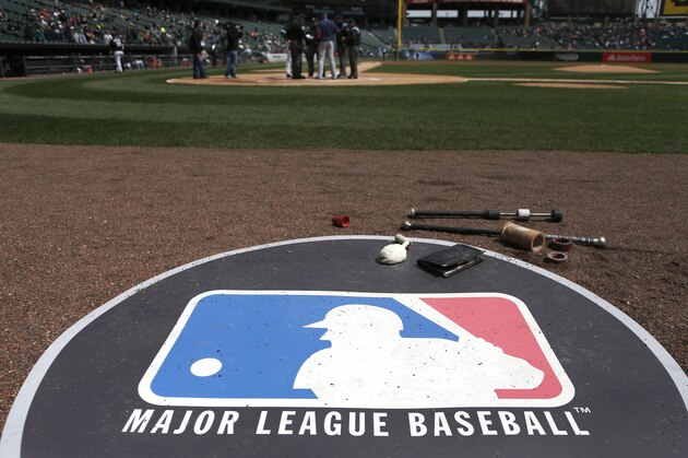 The Major League Baseball logo serves as the visitor's on deck circle before a baseball game between the Chicago White Sox and the Cleveland Indians Wednesday, April 24, 2013, in Chicago. (AP Photo/Charles Rex Arbogast)