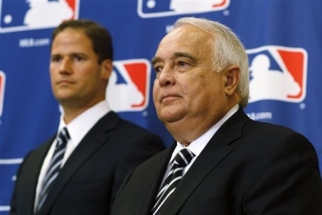 Ron Fowler, right, andns Kevin O'Malley listen during the announcement of the approval of the sale of the San Diego Padres to a ownership group headed by Fowler and members of the O'Malley family of Los Angeles Dodgers fame following a meeting of baseball owners in Denver on Thursday, Aug. 16, 2012. (AP Photo/David Zalubowski)