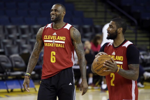 Cleveland Cavaliers' LeBron James, left, jokes with teammate Kyrie Irving (2) during NBA basketball practice Wednesday, June 1, 2016, in Oakland, Calif. The Golden State Warriors host the Cavaliers in Game 1 of the NBA finals on Thursday. (AP Photo/Marcio Jose Sanchez)