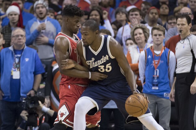 OKLAHOMA CITY, OK - DECEMBER 25: Kevin Durant #35 of the Oklahoma City Thunder pushes against Jimmy Butler #21 of the Chicago Bulls during the first quarter of a NBA game at the Chesapeake Energy Arena on December 25, 2015 in Oklahoma City, Oklahoma. NOTE TO USER: User expressly acknowledges and agrees that, by downloading and or using this photograph, User is consenting to the terms and conditions of the Getty Images License Agreement. (Photo by J Pat Carter/Getty Images)