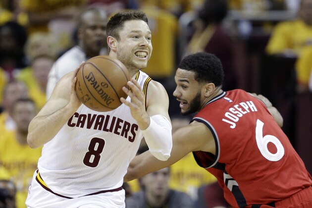 Cleveland Cavaliers' Matthew Dellavedova (8), from Australia,  looks to pass against Toronto Raptors' Cory Joseph (6), from Canada, during the first half of Game 2 of the NBA basketball Eastern Conference finals Thursday, May 19, 2016, in Cleveland. (AP Photo/Tony Dejak)