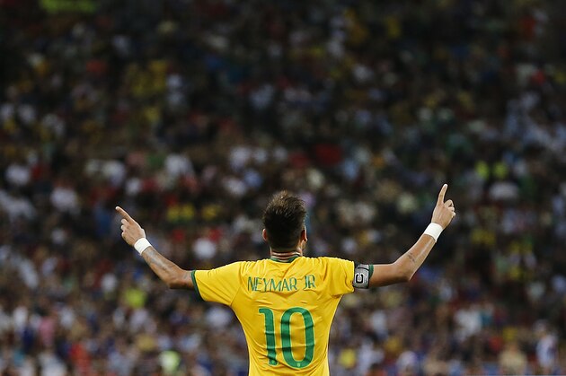 FILE - In this Oct. 14, 2014, file photo, Brazil's Neymar celebrates after scoring the forth goal during an international friendly soccer match in Singapore. (AP Photo/Wong Maye-E,File)