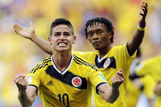 FILE - In this June 19, 2014, file photo, Colombia's James Rodriguez (10) celebrates with teammate Colombia's Juan Cuadrado after scoring his side's first goal during the group C World Cup soccer match between Colombia and Ivory Coast at the Estadio Nacional in Brasilia, Brazil. (AP Photo/Fernando Llano, File)