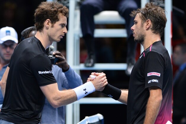 Britain's Andy Murray (L) shakes hands with Switzerland's Stan Wawrinka after losing a men's singles group stage match on day six of the ATP World Tour Finals tennis tournament in London on November 20, 2015.  
AFP PHOTO / GLYN KIRK        (Photo credit should read GLYN KIRK/AFP/Getty Images)