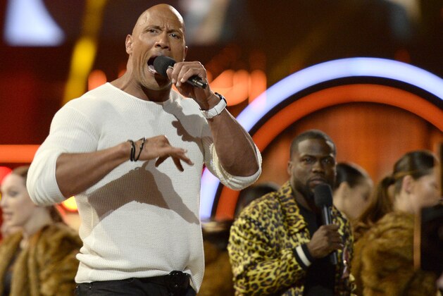 Hosts Dwayne Johnson, left, and Kevin Hart perform a tribute to the 25th anniversary of the MTV Movie Awards at Warner Bros. Studio on Saturday, April 9, 2016, in Burbank, Calif. (Kevork Djansezian/Pool Photo via AP)