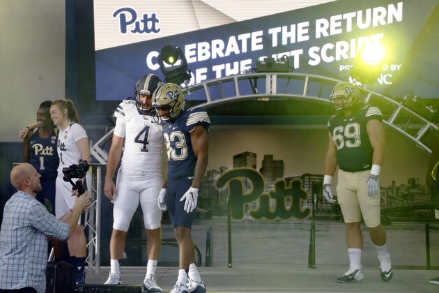 Pittsburgh quarterback Nate Peterman (4) and teammates Jordan Whitehead (33) and Adam Bisnowaty (69) are photographed as they model new uniforms that also feature the