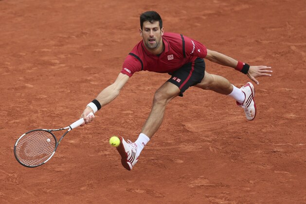 Serbia's Novak Djokovic returns the ball in the quarterfinal match of the French Open tennis tournament against Tomas Berdych of the Czech Republic at the Roland Garros stadium in Paris, France, Thursday, June 2, 2016. (AP Photo/David Vincent)
