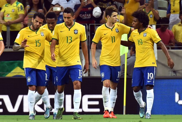 Brazil's Willian(19) celebrates with Oscar(11), Marquinhos(13) and Dani Alves after scoring against Venezuela during their Russia 2018 FIFA World Cup South American Qualifiers football match, at the Estadio Castelao stadium in Fortaleza, Brazil, on October 13, 2015. AFP PHOTO / NELSON ALMEIDA        (Photo credit should read NELSON ALMEIDA/AFP/Getty Images)