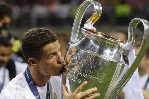 Real Madrid's Cristiano Ronaldo kisses the trophy after the Champions League final soccer match between Real Madrid and Atletico Madrid at the San Siro stadium in Milan, Italy, Saturday, May 28, 2016. Real Madrid won 5-3 on penalties after the match ended 1-1 after extra time.  (AP Photo/Andrew Medichini)