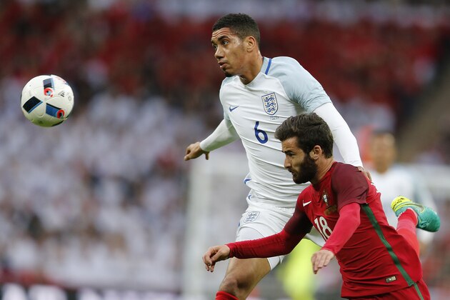 England's Chris Smalling, left, and Portugal's Rafa Silva challenge for the ball during the International friendly soccer match between England and Portugal at Wembley stadium in London, England, Thursday, June 2, 2016 . (AP Photo/Frank Augstein)
