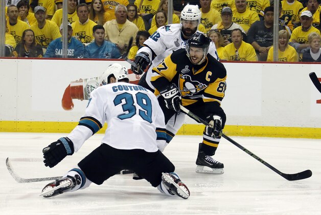 Pittsburgh Penguins' Sidney Crosby (87) tries to pass against San Jose Sharks' Logan Couture (39) and Patrick Marleau (12) during the first period of Game 1 of the Stanley Cup final series Monday, May 30, 2016, in Pittsburgh. (AP Photo/Keith Srakocic)