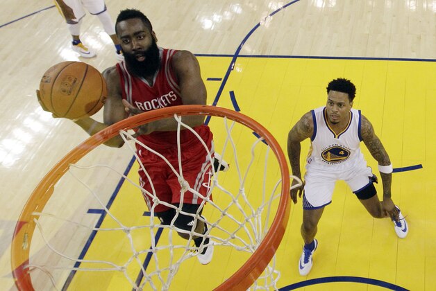 Houston Rockets' James Harden, left, drives past Golden State Warriors' Brandon Rush (4) during the second half of Game 5 of a first-round NBA basketball playoff series Wednesday, April 27, 2016, in Oakland, Calif. Golden State won 114-81.  (AP Photo/Marcio Jose Sanchez)