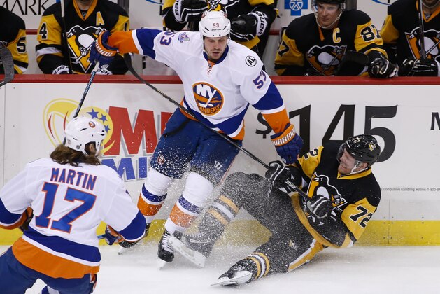 Pittsburgh Penguins' Patric Hornqvist (72) collides with New York Islanders' Casey Cizikas (53) during the third period of an NHL hockey game in Pittsburgh, Saturday, Jan. 2, 2016. The Penguins won 5-2. (AP Photo/Gene J. Puskar)