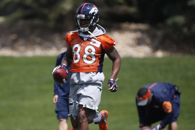 In this Tuesday, May 31, 2016, photograph, Denver Broncos wide receiver Demaryius Thomas finishes a pass route during an NFL football practice at the team's headquarters in Englewood, Colo. Thomas will join his teammates who won Super Bowl 50 in a visit to the White House on Monday, June 6. While there, Thomas will deliver a hand-written letter to President Barack Obama to thank him for commuting the drug sentence that Thomas's mother was serving. (AP Photo/David Zalubowski)