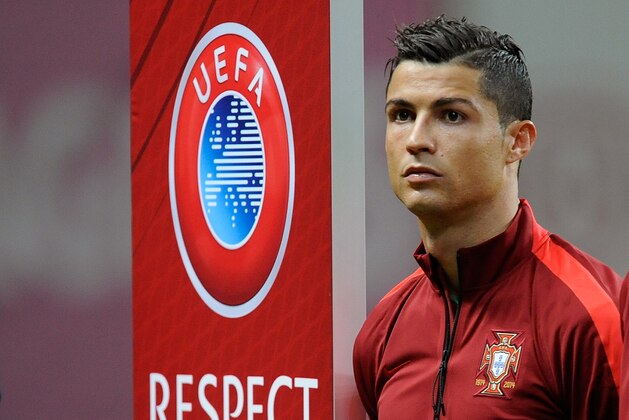 Portugal’s Cristiano Ronaldo stands on the pitch before the start of the Euro 2016 qualifying group I soccer match between Portugal and Denmark at the Municipal Stadium in Braga, Portugal, Thursday, Oct. 8 2015. (AP Photo/Paulo Duarte)
