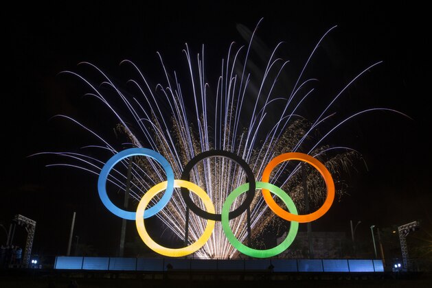 FILE - In this May 20, 2015 file photo, fireworks explode behind the Olympic rings during their inauguration ceremony at Madureira Park in Rio de Janeiro, Brazil. Some people in Brazil are trying to scalp tickets for the Rio de Janeiro Olympics, even before the tickets are issued. Rio de Janeiro Police Investigator Gilberto Ribeiro said on Tuesday, April 5, 2016 that 10 people have been detected using social media trying to sell ticket vouchers, to be exchanged for tickets, at up to double their face value. (AP Photo/Felipe Dana, File)