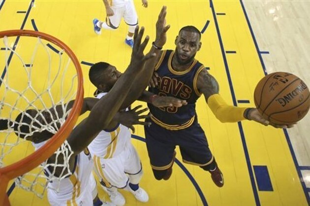 Cleveland Cavaliers forward LeBron James, right, shoots against the Golden State Warriors during the second half of Game 2 of basketball's NBA Finals in Oakland, Calif., Thursday, June 2, 2016. The Warriors won 104-89. (Ezra Shaw, Getty Images via AP, Pool)
