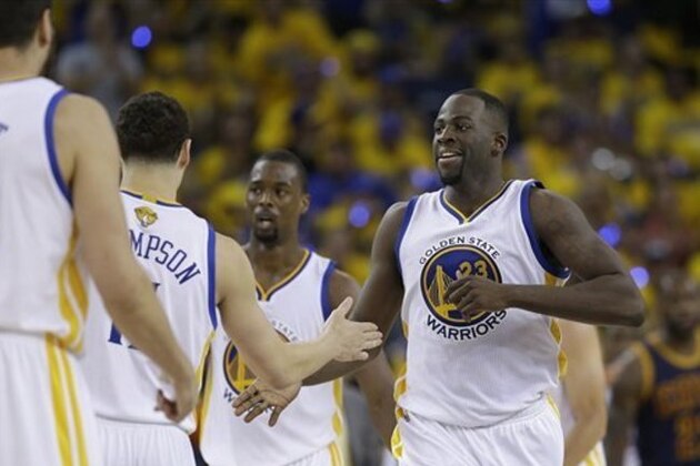Golden State Warriors forward Draymond Green (23) is greeted by teammates during the second half of Game 1 of basketball's NBA Finals against the Cleveland Cavaliers in Oakland, Calif., Thursday, June 2, 2016. (AP Photo/Marcio Jose Sanchez)