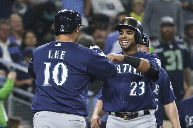 Seattle Mariners' Dae-Ho Lee is greeted by Nelson Cruz after hitting a three-run home run against the San Diego Padres during the sixth inning of a baseball game Thursday, June 2, 2016, in San Diego. The Mariners scored five runs in the sixth inning and nine runs in the seventh, and won 16-13. (AP Photo/Lenny Ignelzi)
