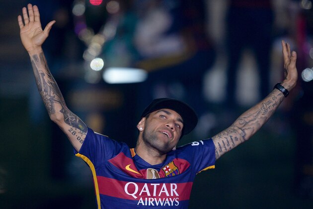 Barcelona's Brazilian defender Dani Alves acknowledges the crowd during celebrations at the Camp Nou stadium in Barcelona on May 23, 2016 following their Spanish 'Copa del Rey' (King's Cup) final football match 2-0 victory over Sevilla FC yesterday also marking the club's 28th Copa del Rey win and the 24th Spanish Liga title. / AFP / JOSEP LAGO        (Photo credit should read JOSEP LAGO/AFP/Getty Images)