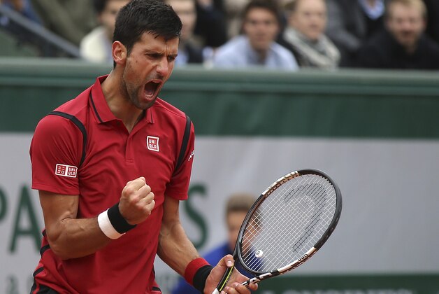 Serbia's Novak Djokovic clenches his fist as he plays Austria's Dominic Thiem during their semifinal match of the French Open tennis tournament at the Roland Garros stadium, Friday, June 3, 2016 in Paris. (AP Photo/Michel Euler)