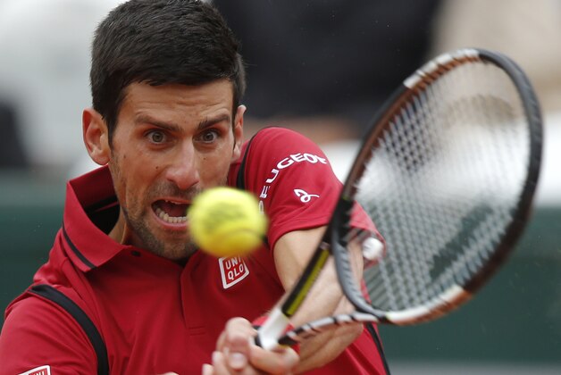 Serbia's Novak Djokovic returns the ball to Austria's Dominic Thiem during their semifinal match of the French Open tennis tournament at the Roland Garros stadium, Friday, June 3, 2016 in Paris. (AP Photo/Michel Euler)