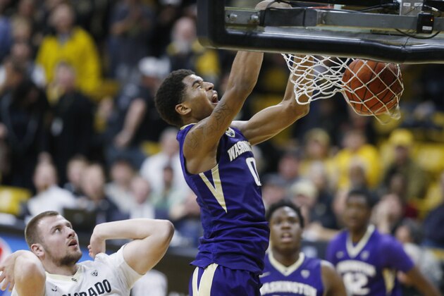 Washington forward Marquese Chriss, right, reacts as he dunks the ball for a basket over Colorado forward Kenan Guzonjic in the first half of an NCAA college basketball game Saturday, Feb. 13, 2016, in Boulder, Colo. (AP Photo/David Zalubowski)