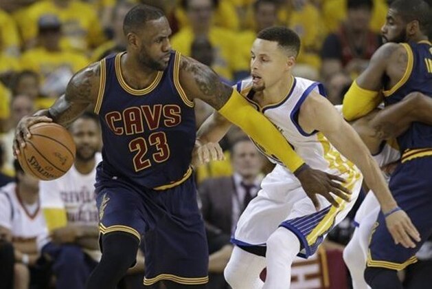 Cleveland Cavaliers forward LeBron James (23) dribbles against Golden State Warriors guard Stephen Curry during the first half of Game 1 of basketball's NBA Finals in Oakland, Calif., Thursday, June 2, 2016. (AP Photo/Marcio Jose Sanchez)