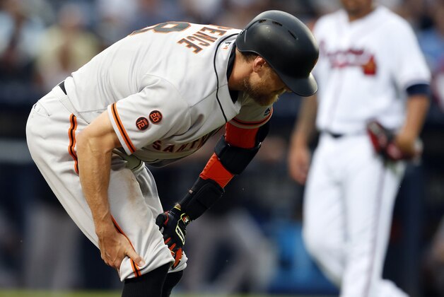 San Francisco Giants' Hunter Pence pulls up and grabs his leg as he ran to first during the fourth inning of a baseball game against the Atlanta Braves, Wednesday, June 1, 2016, in Atlanta. (AP Photo/Butch Dill)