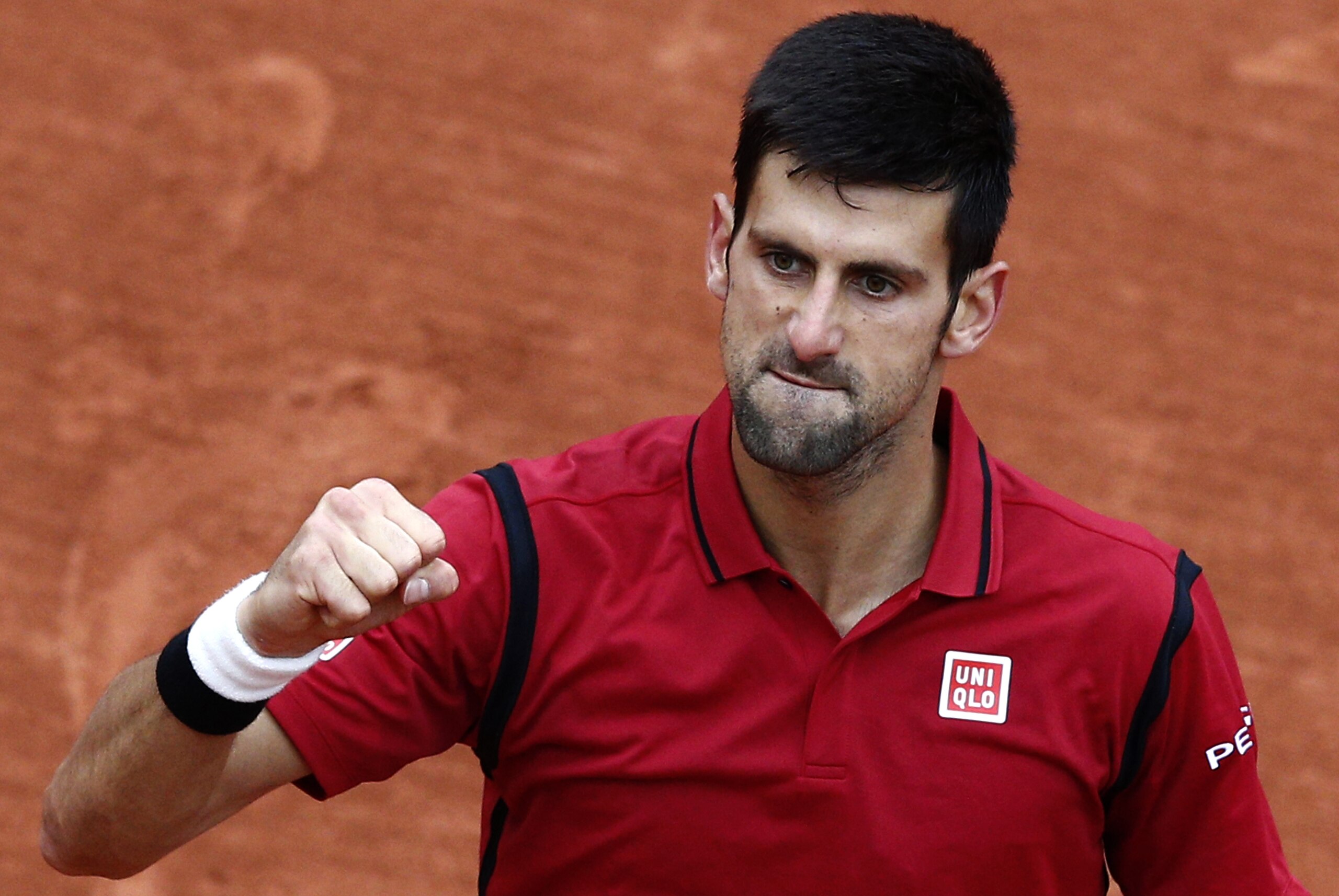 Serbia's Novak Djokovic clenches his fist after defeating Austria's Dominic Thiem during their semifinal match of the French Open tennis tournament at the Roland Garros stadium, Friday, June 3, 2016 in Paris. (AP Photo/Christophe Ena)