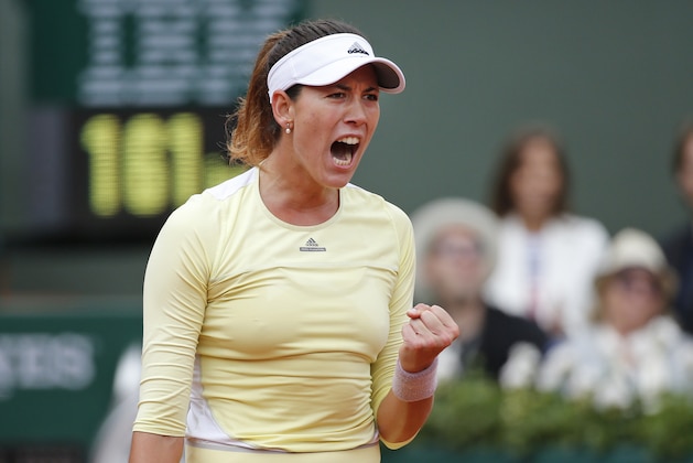 Spain's Garbine Muguruza clenches her fist after scoring a point in the final of the French Open tennis tournament against Serena Williams of the U.S. at the Roland Garros stadium in Paris, France, Saturday, June 4, 2016. (AP Photo/Alastair Grant)