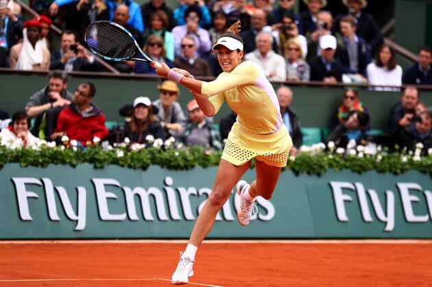PARIS, FRANCE - JUNE 04:  Garbine Muguruza of Spain hits a backhand during the Ladies Singles final match against Serena Williams of the United States on day fourteen of the 2016 French Open at Roland Garros on June 4, 2016 in Paris, France.  (Photo by Julian Finney/Getty Images)