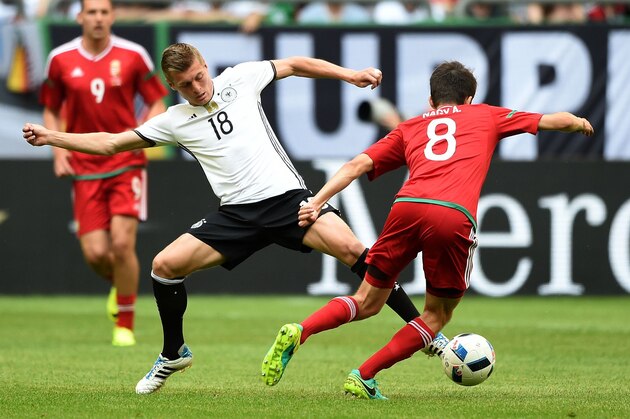 Germany's midfielder Toni Kroos (L) and Hungary´s Adam Nagy vie during the UEFA EURO 2016 friendly football match Germany vs Hungary at the Veltins Arena in Gelsenkirchen, western Germany on June 4, 2016. / AFP / PATRIK STOLLARZ        (Photo credit should read PATRIK STOLLARZ/AFP/Getty Images)