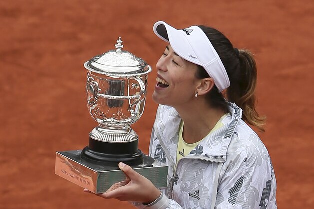 Spain's Garbine Muguruza holds the trophy after winning the final of the French Open tennis tournament against Serena Williams of the U.S. in two sets 7-5, 6-4, at the Roland Garros stadium in Paris, France, Saturday, June 4, 2016. (AP Photo/David Vincent)