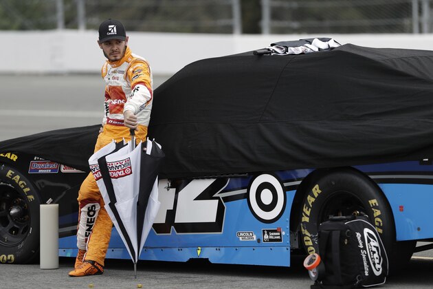Kyle Larson stands with his car during a rain delay in the NASCAR Xfinity series auto race at Pocono Raceway, Saturday, June 4, 2016, in Long Pond, Pa. (AP Photo/Matt Slocum)