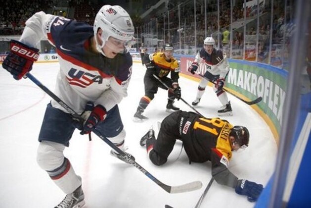 FILE - In this May 15, 2016 file photo, United States' Auston Matthews, left, fights for the puck with Germany’s Torsten Ankert during a Hockey World Championships Group B match in St.Petersburg, Russia. Matthews spent the past year playing in Switzerland, where he established himself as the NHL's top-ranked draft prospect. Matthews is from Arizona and among more than 100 draft-eligible players taking part in the league's rookie combine in Buffalo. (AP Photo/Dmitri Lovetsky, File)