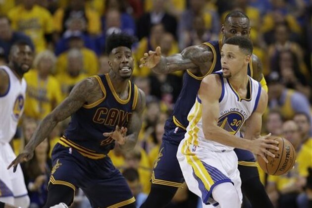 Golden State Warriors guard Stephen Curry (30) is guarded by Cleveland Cavaliers forward LeBron James and guard Iman Shumpert (4) during the second half of Game 1 of basketball's NBA Finals in Oakland, Calif., Thursday, June 2, 2016. (AP Photo/Marcio Jose Sanchez)