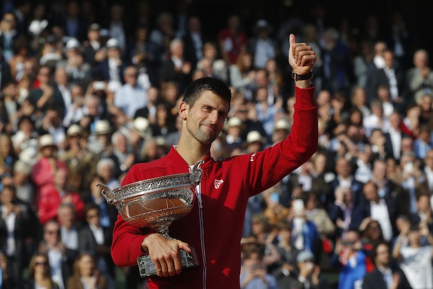 Serbia's Novak Djokovic gives a thumbs up as he holds the trophy after winning the final of the French Open tennis tournament against Britain's Andy Murray in four sets 3-6, 6-1, 6-2, 6-4, at the Roland Garros stadium in Paris, France, Sunday, June 5, 2016. (AP Photo/Michel Euler)