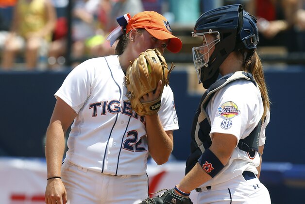 Auburn pitcher Marcy Harper, left, talks with catcher Carlee Wallace, right, in the third inning of a game against LSU in the NCAA Women's College World Series softball tournament in Oklahoma City, Thursday, May 28, 2015. LSU won 6-1. (AP Photo/Sue Ogrocki)