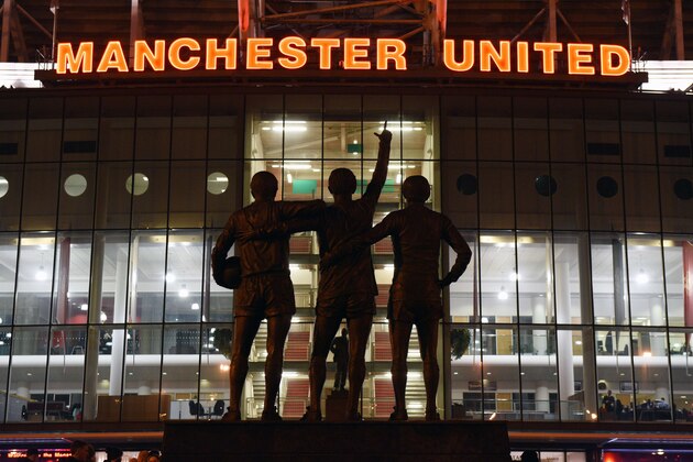 A general view outside Old Trafford stadium and 'The United Trinity' statue of former Manchester United players George Best, Denis Law, and Bobby Charlton seen ahead of the English Premier League football match between Manchester United and Burnley at Old Trafford in Manchester, north west England, on February 11, 2015.  AFP PHOTO / OLI SCARFF

RESTRICTED TO EDITORIAL USE. No use with unauthorized audio, video, data, fixture lists, club/league logos or live services. Online in-match use limited to 45 images, no video emulation. No use in betting, games or single club/league/player publications.        (Photo credit should read OLI SCARFF/AFP/Getty Images)