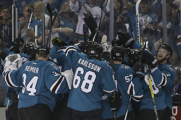 San Jose Sharks players celebrate after Joonas Donskoi scored the winning goal against the Pittsburgh Penguins during overtime of Game 3 of the NHL hockey Stanley Cup Finals in San Jose, Calif., Saturday, June 4, 2016. The Sharks won 3-2. (AP Photo/Marcio Jose Sanchez)