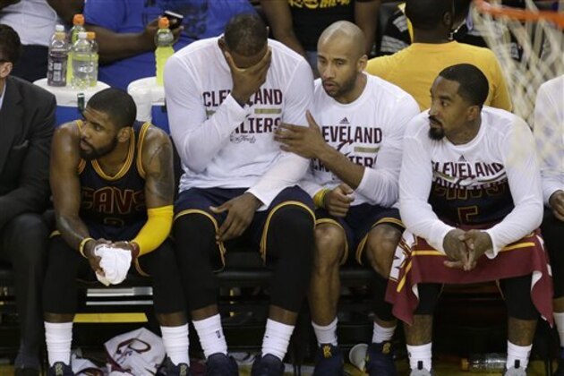 Cleveland Cavaliers' Kyrie Irving, from left, LeBron James, Dahntay Jones and J.R. Smith sit on the bench during the second half of Game 2 of basketball's NBA Finals against the Golden State Warriors in Oakland, Calif., Sunday, June 5, 2016. (AP Photo/Ben Margot)